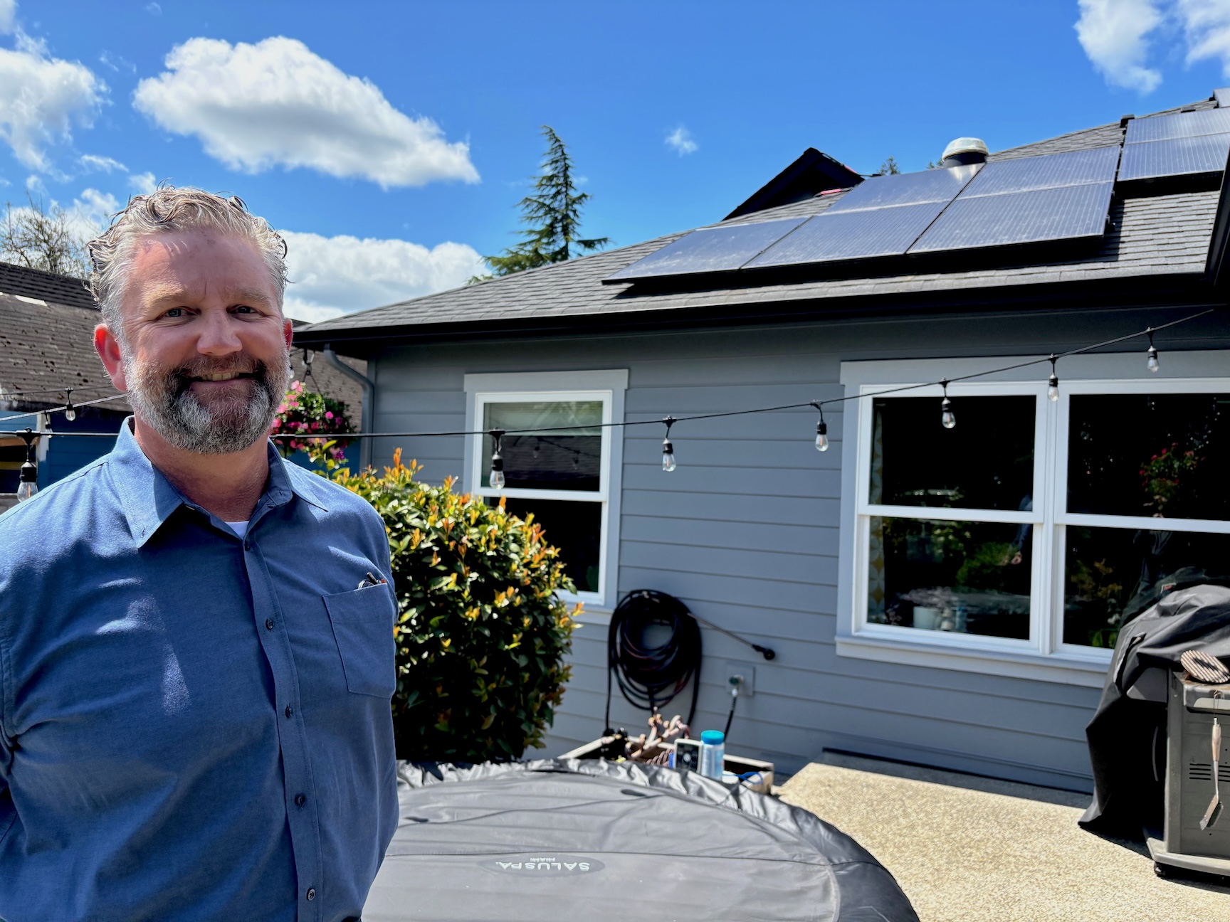 Jeff Bennett pictured in front of solar panels on his roof.
